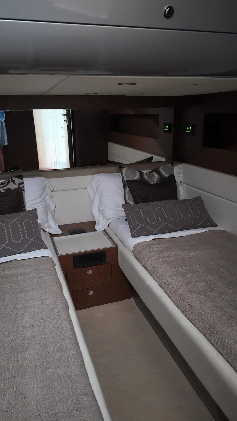Slide: The Image of Luxurious 2012 Riva Rivale yacht cabin with twin beds and elegant decor. - 48