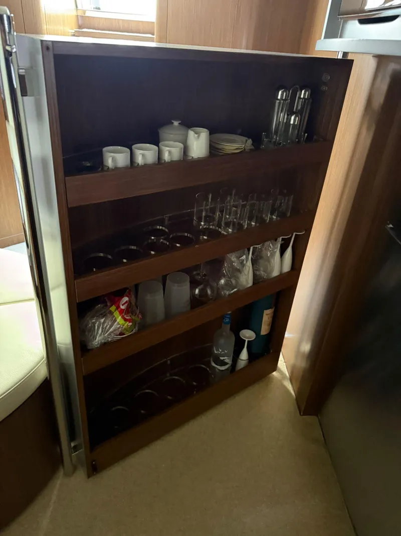 Slide: The Image of Cabinet with glassware and bottles inside a 2012 Riva Rivale yacht. - 55