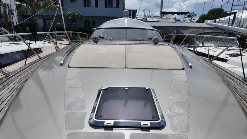 Slide: The Image of 2012 Riva Rivale yacht deck with sleek design and sunroof, docked at marina. - 6