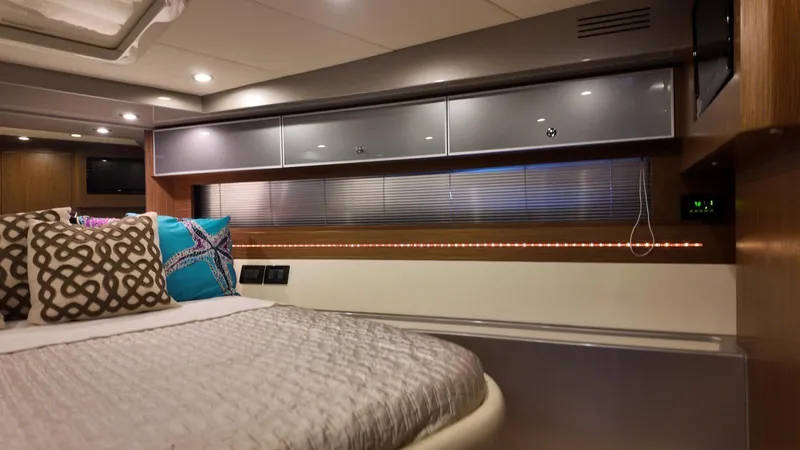 Slide: The Image of Luxurious interior of a 2012 Riva Rivale yacht cabin with modern decor and ambient lighting. - 60