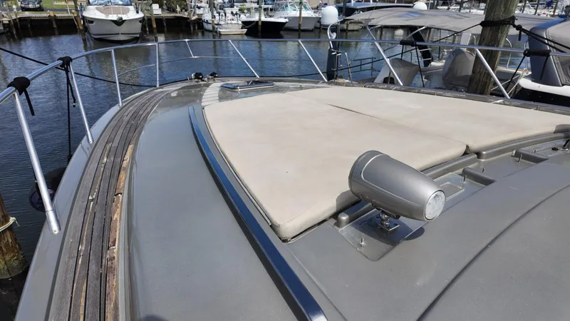 Slide: The Image of 2012 Riva Rivale yacht deck with sunpad and spotlight, docked in marina. - 8