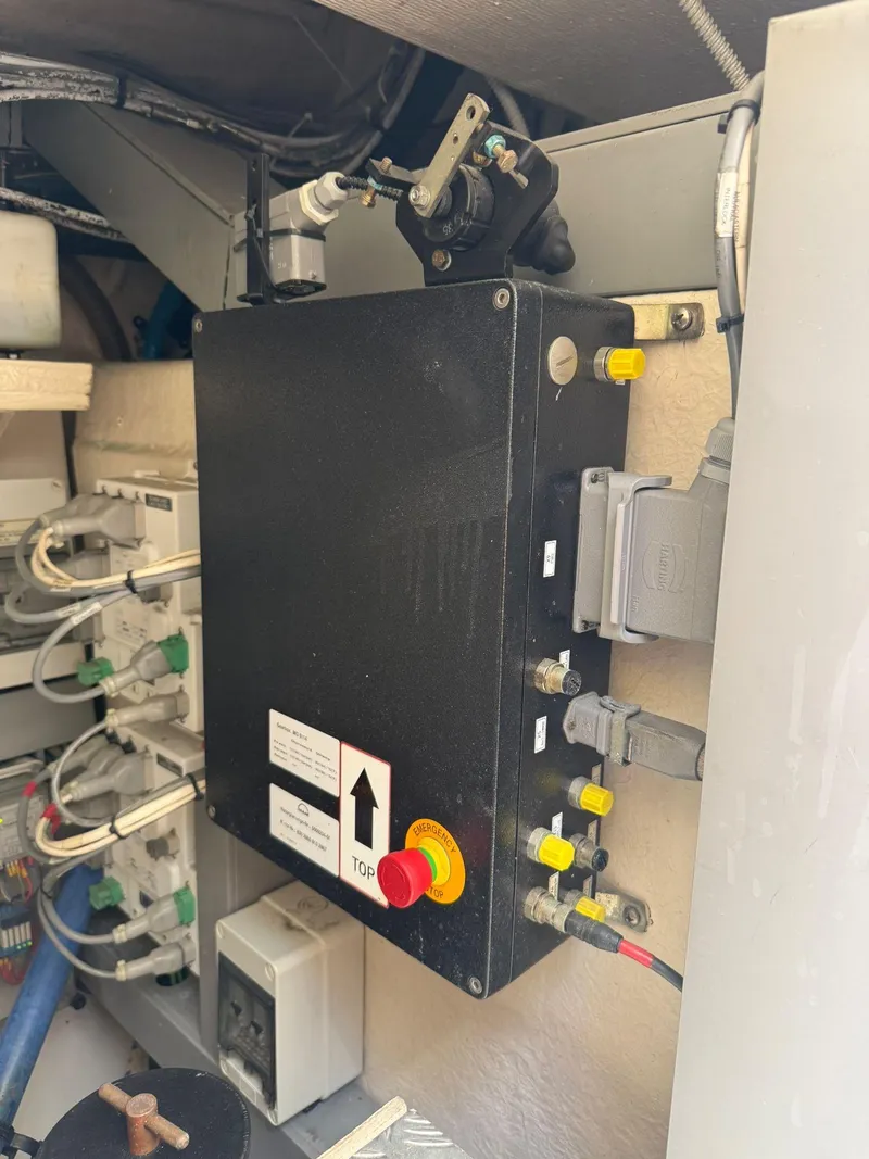 Slide: The Image of Engine compartment of a 2012 Riva Rivale, featuring control panel and wiring. - 84