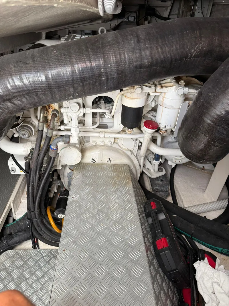 Slide: The Image of Engine compartment of a 2012 Riva Rivale yacht, featuring hoses and mechanical components. - 86