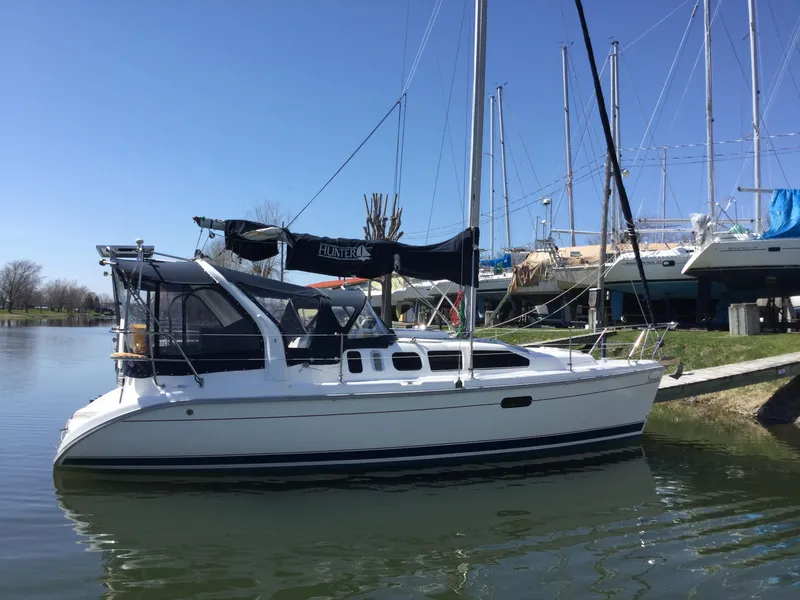 The Image of Hunter 310 sailboat from 1997 docked on a calm waterway. - 1