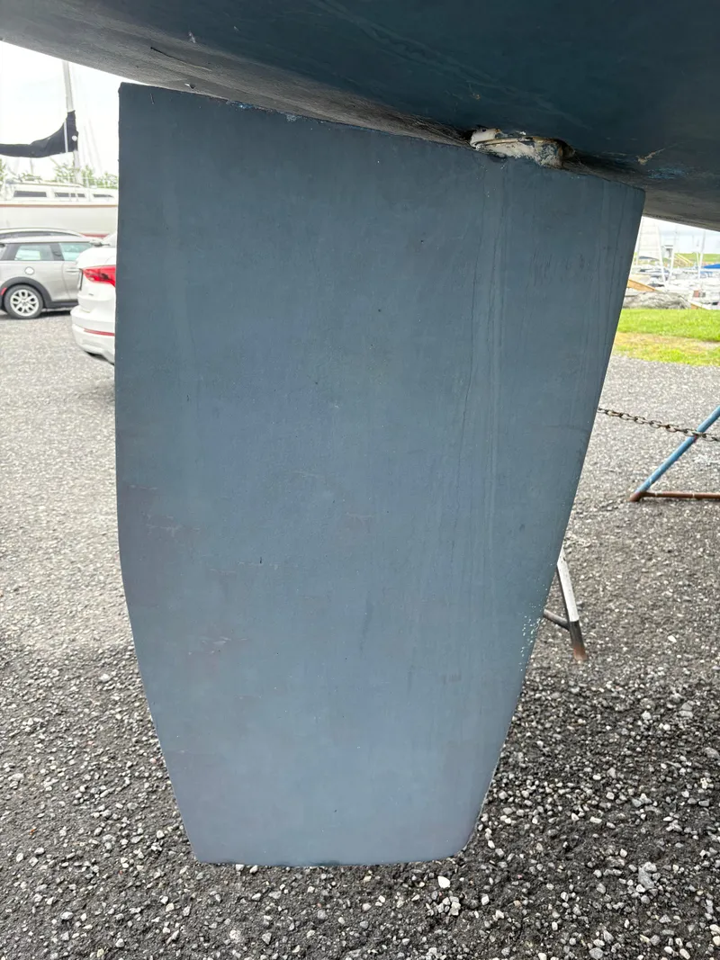 Slide: The Image of Close-up of a 1997 Hunter 310 sailboat keel on a gravel surface. - 12