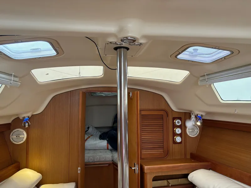 Slide: The Image of Interior of a 1997 Hunter 310 sailboat cabin with wooden finishes and skylights. - 21