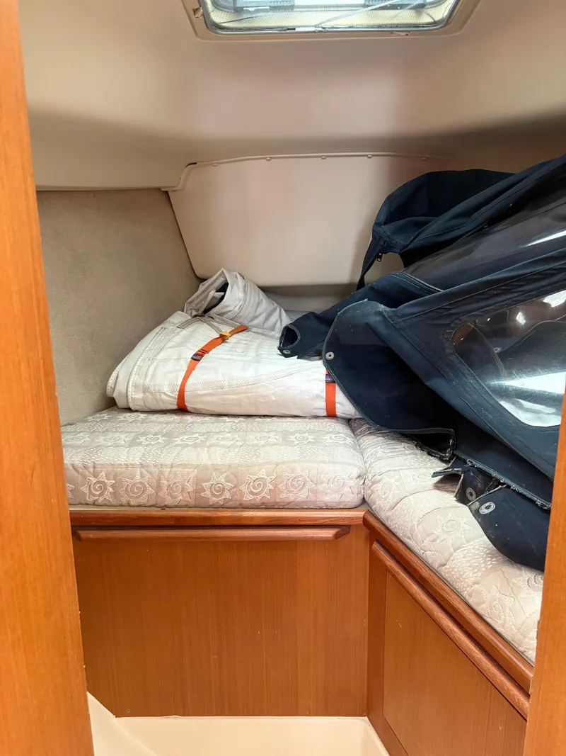 Slide: The Image of Cozy cabin interior of 1997 Hunter 310 sailboat with cushions and storage. - 24