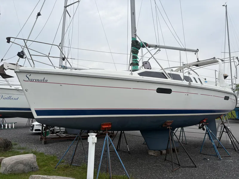 Slide: The Image of 1997 Hunter 310 sailboat named "Sarmata" on stands in a boatyard. - 6
