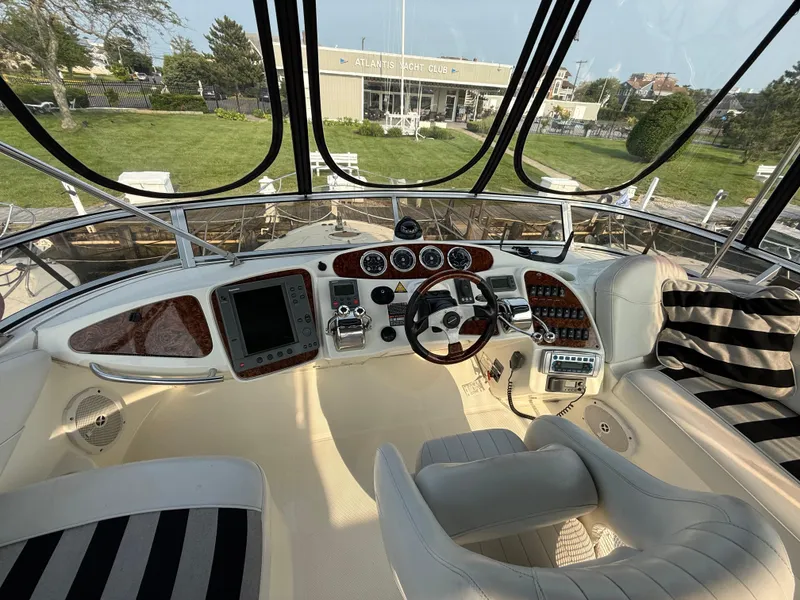 Slide: The Image of Interior view of 2005 Meridian 459 Motoryacht cockpit with luxurious seating and control panel. - 17