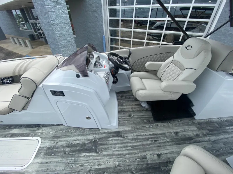 Slide: The Image of 2020 Crest Savannah 250 SLRC boat interior with luxurious seating and modern dashboard. - 13