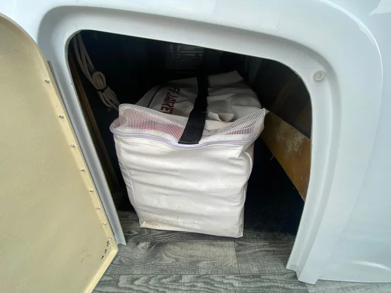 Slide: The Image of Storage compartment in 2020 Crest Savannah 250 SLRC with a white bag inside. - 15