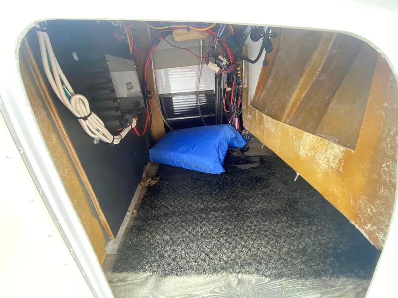 Slide: The Image of Interior storage compartment of 2020 Crest Savannah 250 SLRC boat with wiring and blue cushion. - 16