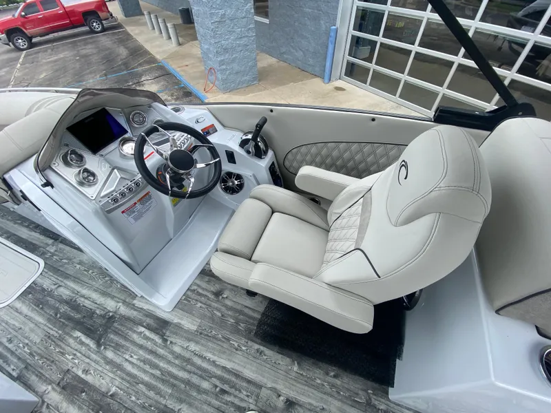 Slide: The Image of Luxurious helm of 2020 Crest Savannah 250 SLRC boat with plush seating and modern controls. - 17