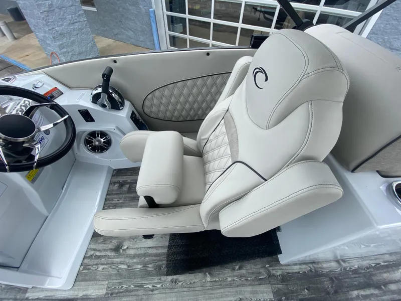 Slide: The Image of Captain's chair in 2020 Crest Savannah 250 SLRC boat, featuring luxurious design and controls. - 18