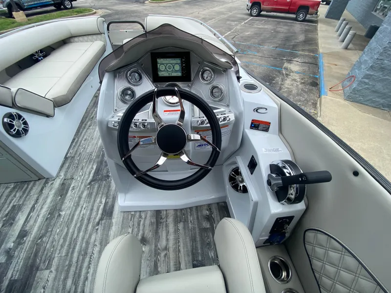 Slide: The Image of 2020 Crest Savannah 250 SLRC boat interior with modern steering console and seating. - 20