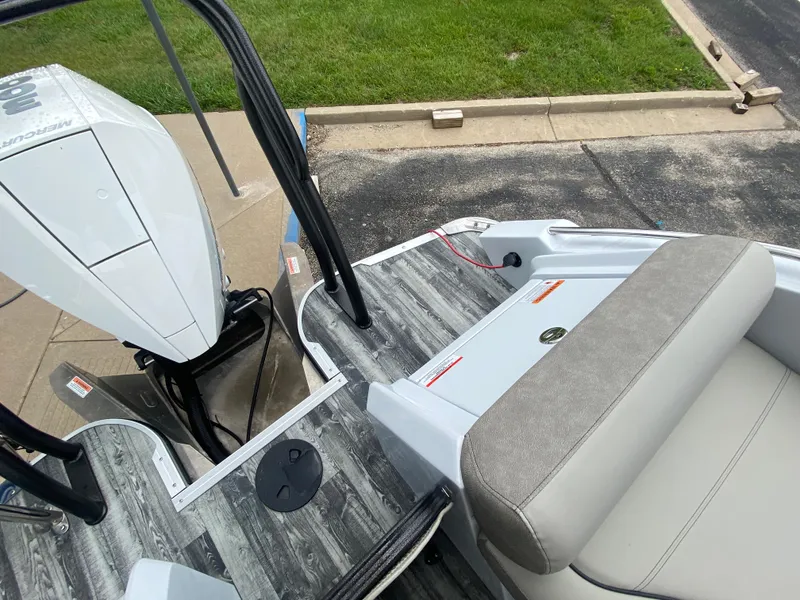 Slide: The Image of 2020 Crest Savannah 250 SLRC boat with modern deck and seating, parked on pavement. - 35
