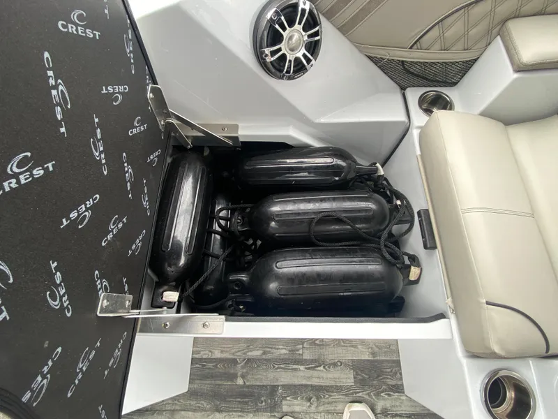 Slide: The Image of Interior storage compartment of 2020 Crest Savannah 250 SLRC boat with fenders and speaker. - 37