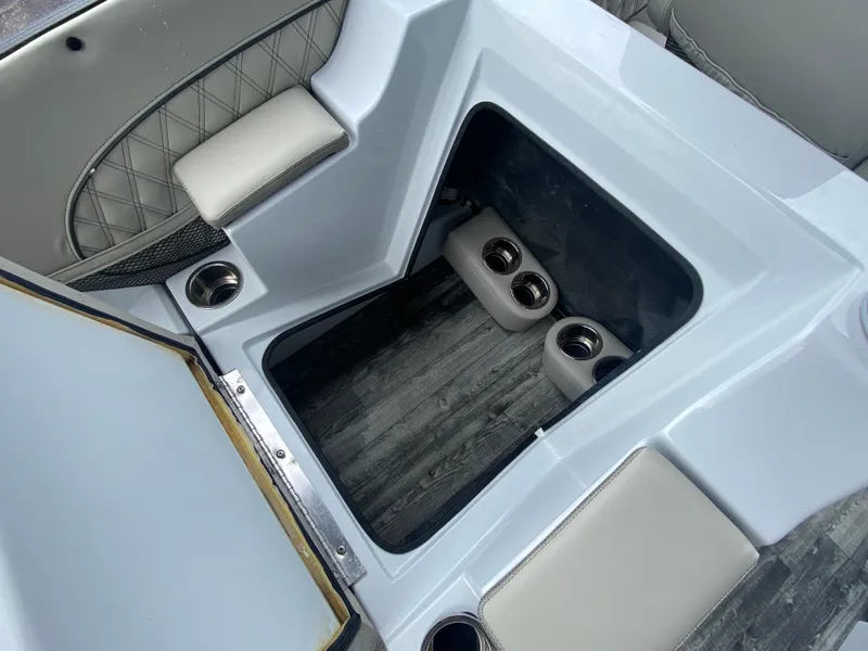 Slide: The Image of Interior of 2020 Crest Savannah 250 SLRC boat with storage compartment and cup holders. - 38