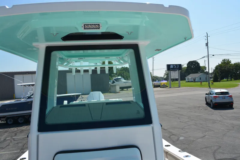 Slide: The Image of 2026 Blackfin 262 HB boat with sleek design, parked outdoors on a sunny day. - 10