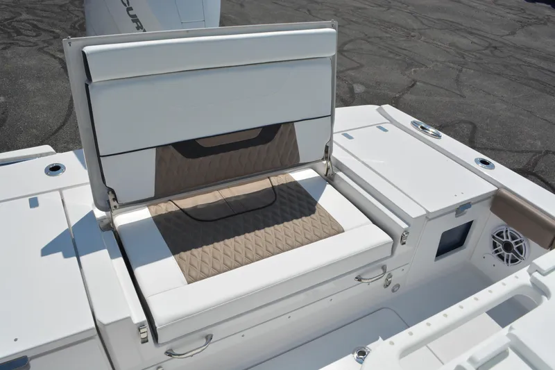 Slide: The Image of 2026 Blackfin 262 HB boat seating area with storage compartment open. - 12
