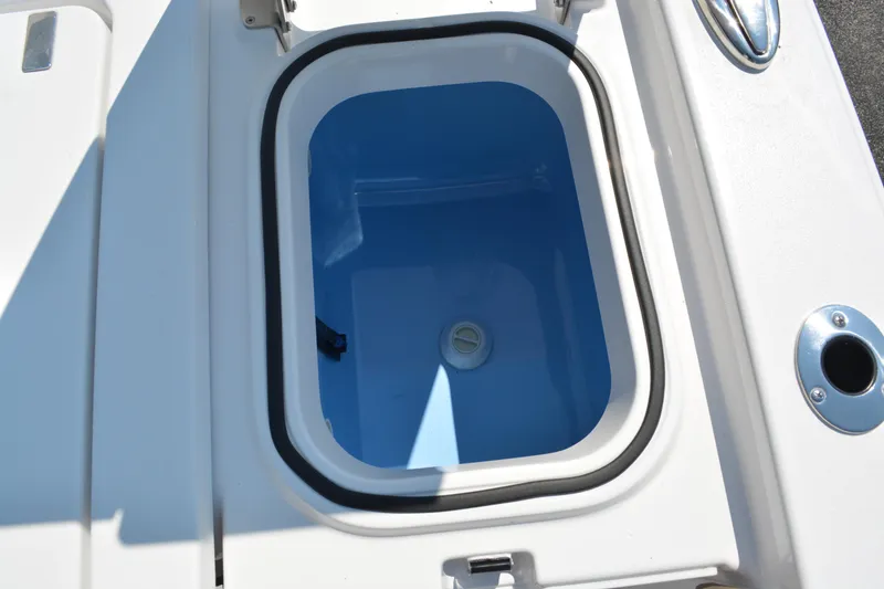 Slide: The Image of Open storage compartment on 2026 Blackfin 262 HB boat, featuring a blue interior. - 16