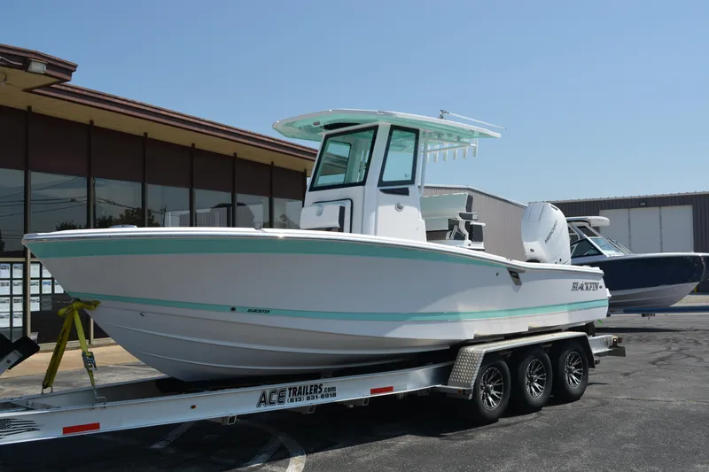 Slide: The Image of 2026 Blackfin 262 HB boat on trailer, displayed outdoors near a building. - 2