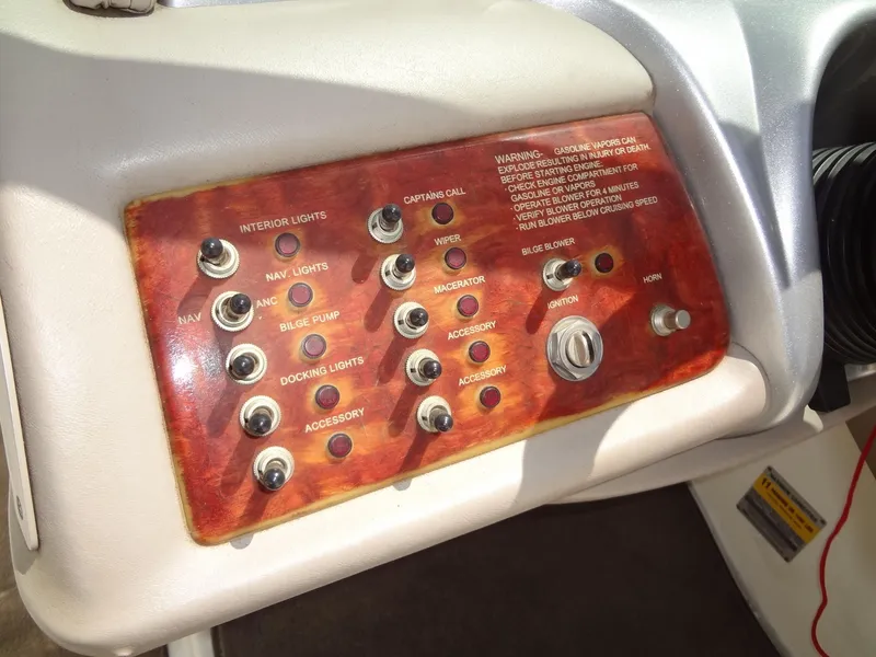 Slide: The Image of Control panel of a 2004 Cobalt 240 boat with various switches and labels. - 15