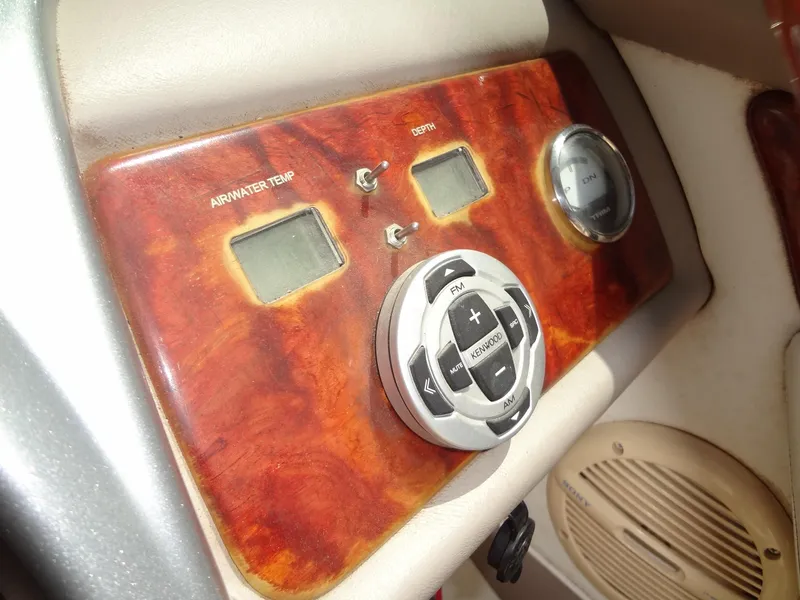 Slide: The Image of Control panel of a 2004 Cobalt 240 boat with wood finish and digital displays. - 17