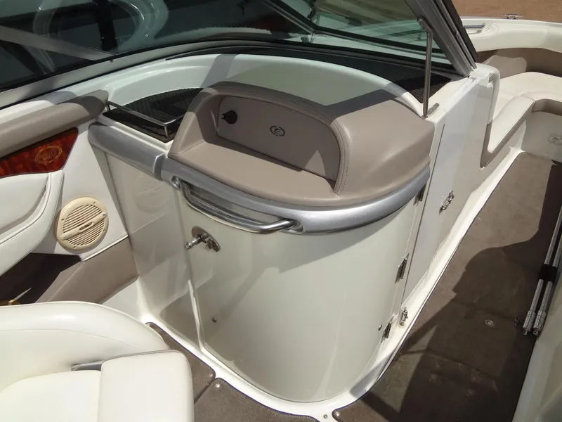 Slide: The Image of 2004 Cobalt 240 boat interior with beige and white seating and dashboard. - 19