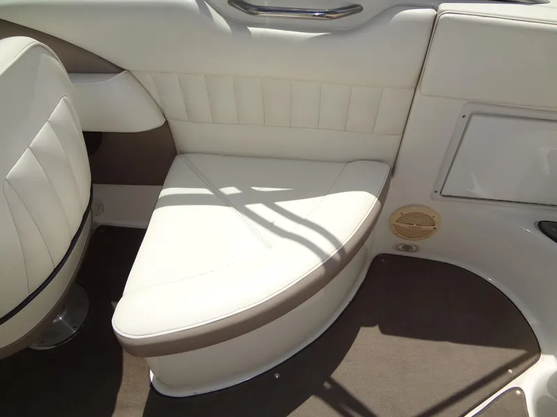Slide: The Image of 2004 Cobalt 240 boat interior with white leather seating and brown accents. - 24