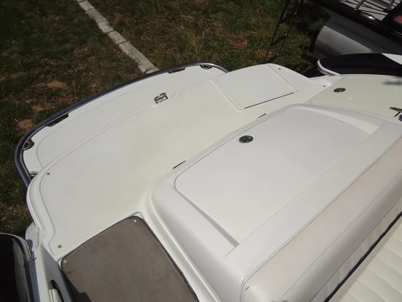 Slide: The Image of 2004 Cobalt 240 boat deck with white seating and storage compartments. - 27