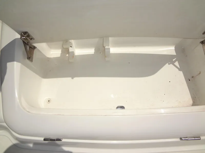 Slide: The Image of Open storage compartment in a 2004 Cobalt 240 boat. - 29