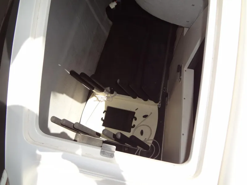 Slide: The Image of Storage compartment of a 2004 Cobalt 240 boat, featuring rod holders and interior space. - 30
