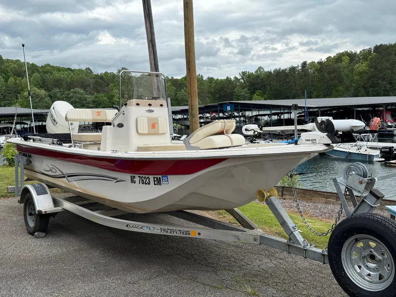Slide: The Image of 2019 Carolina Skiff 18 JVX CC boat on trailer by marina, cloudy sky. - 6
