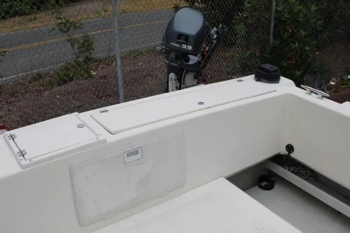 Slide: The Image of 1995 SeaSport 2400 Explorer boat interior with outboard motor in background. - 15