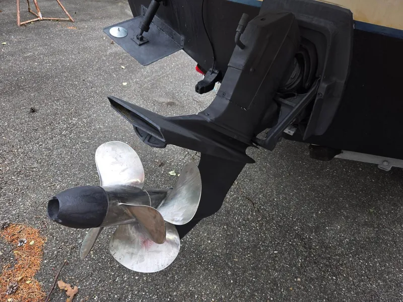 Slide: The Image of Propeller and outboard motor of a 1995 SeaSport 2400 Explorer on pavement. - 17