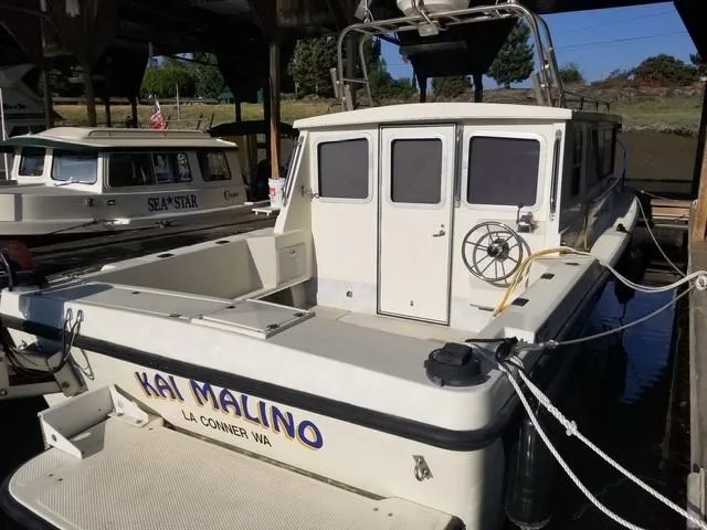 Slide: The Image of 1995 SeaSport 2400 Explorer boat docked, named "Kai Malino," in La Conner, WA. - 2
