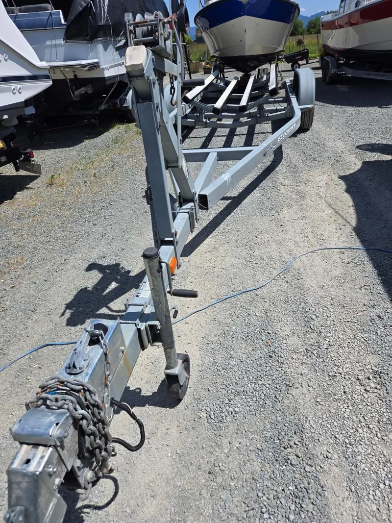 Slide: The Image of Boat trailer for 1995 SeaSport 2400 Explorer on gravel lot. - 20