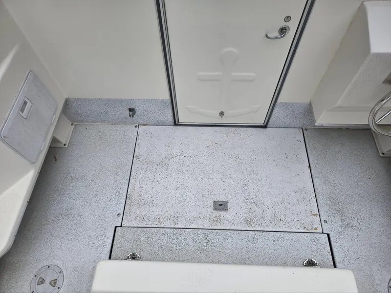 Slide: The Image of 1995 SeaSport 2400 Explorer boat deck with storage compartments and door. - 22