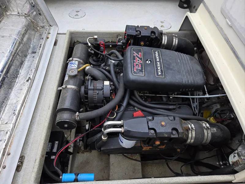 Slide: The Image of Engine compartment of a 1995 SeaSport 2400 Explorer boat, featuring a 7.4L engine. - 28