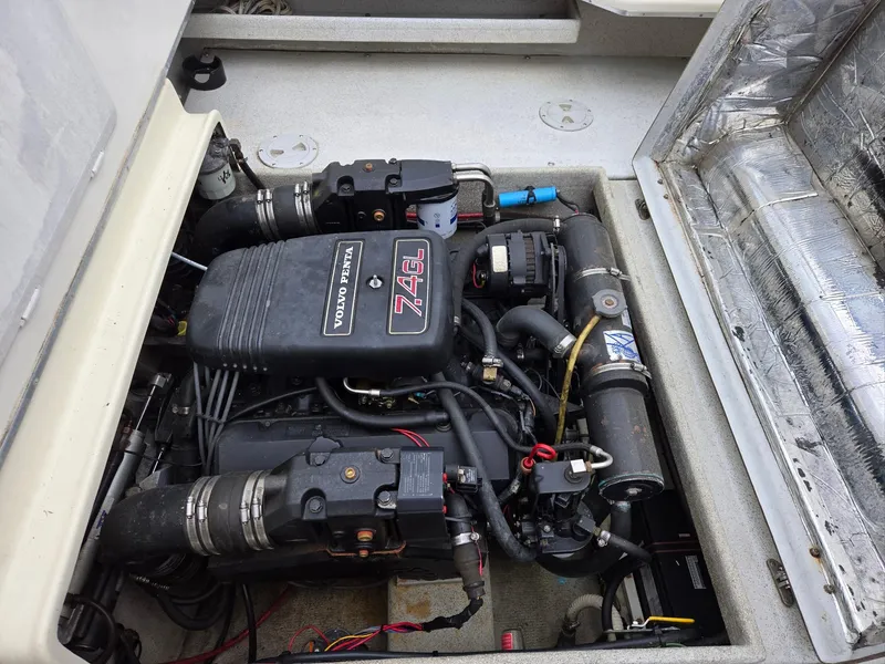 Slide: The Image of Engine compartment of a 1995 SeaSport 2400 Explorer boat, showcasing mechanical components. - 29