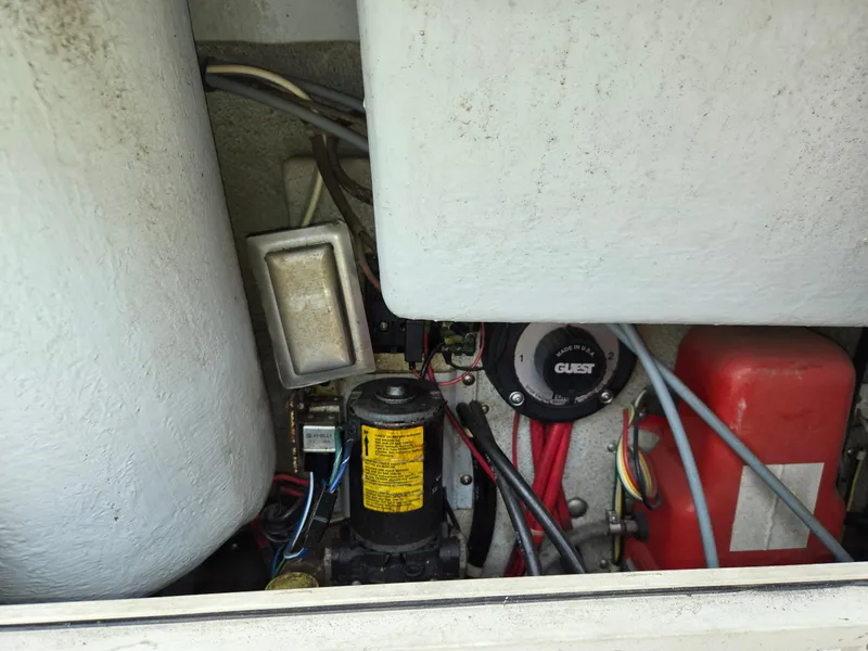 Slide: The Image of Engine compartment of a 1995 SeaSport 2400 Explorer boat, showing various mechanical components. - 31