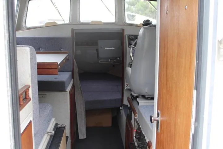 Slide: The Image of Interior of a 1995 SeaSport 2400 Explorer boat, featuring seating and navigation equipment. - 33