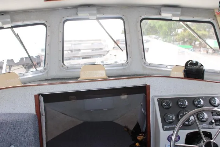 Slide: The Image of Interior view of a 1995 SeaSport 2400 Explorer boat cockpit with steering wheel and gauges. - 34