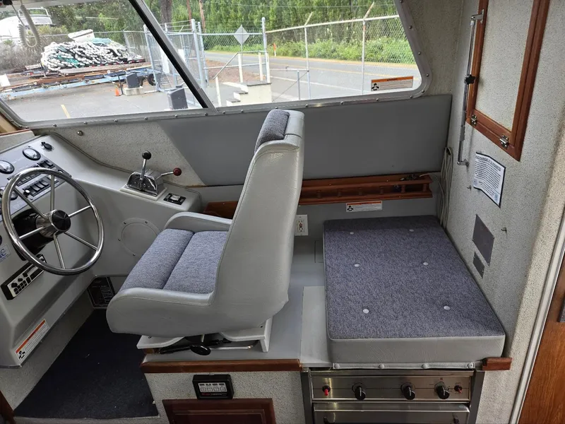 Slide: The Image of Interior of a 1995 SeaSport 2400 Explorer boat with steering wheel and seating area. - 36