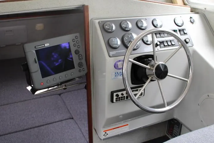 Slide: The Image of 1995 SeaSport 2400 Explorer dashboard with steering wheel and navigation equipment. - 37