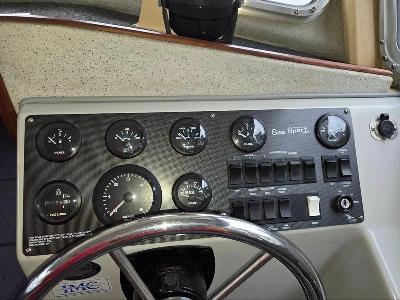 Slide: The Image of 1995 SeaSport 2400 Explorer dashboard with gauges and controls. - 38