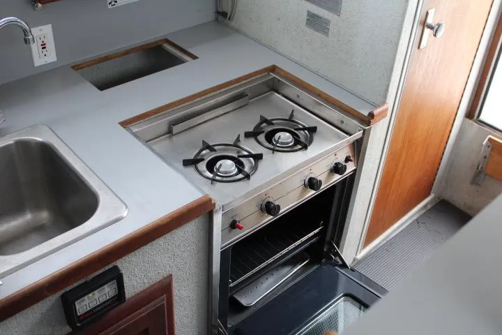Slide: The Image of 1995 SeaSport 2400 Explorer kitchen with stove, oven, and sink. - 47