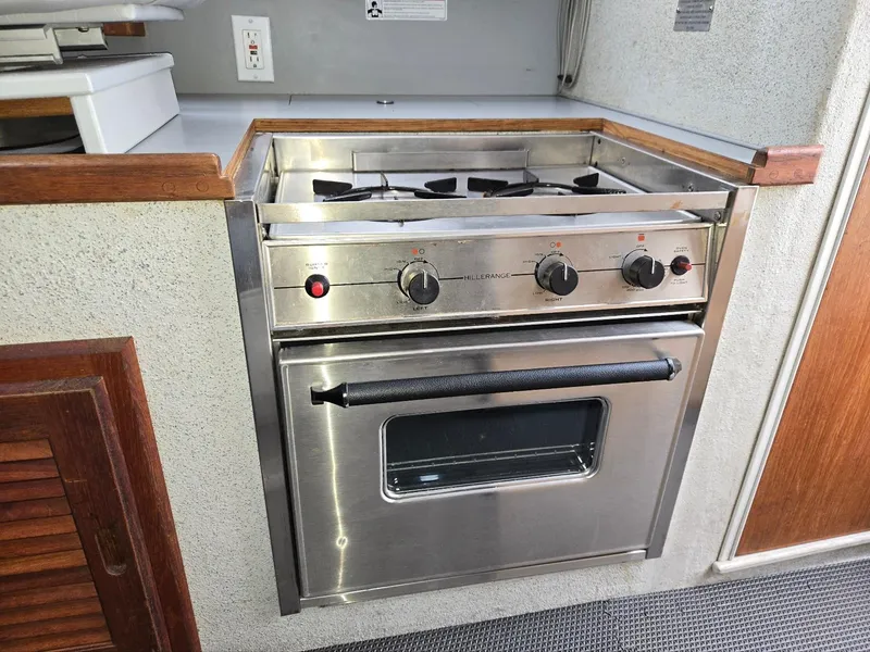 Slide: The Image of Stainless steel stove and oven in 1995 SeaSport 2400 Explorer boat kitchen. - 48