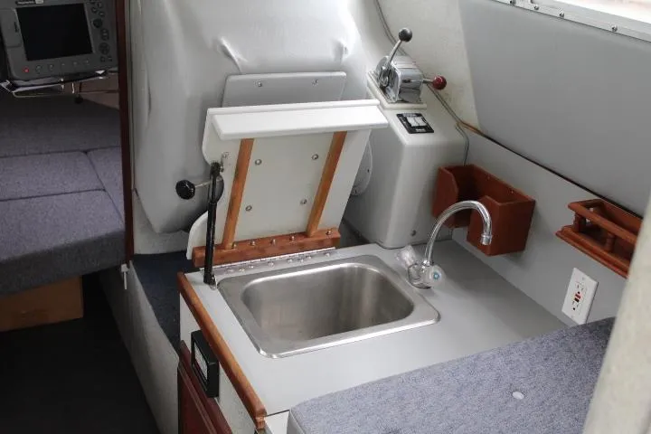 Slide: The Image of Interior of 1995 SeaSport 2400 Explorer boat with sink and control panel. - 49
